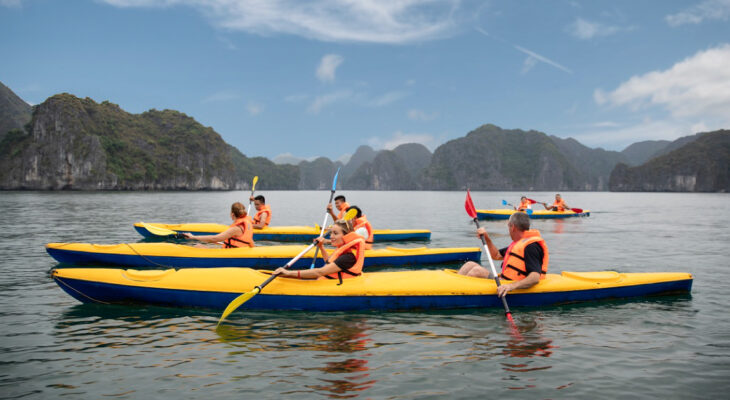Halong Odyssey Cruise guests kayaking in Halong Bay.