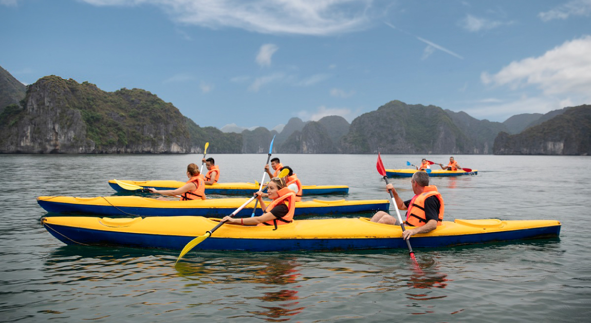 Halong Odyssey Cruise guests kayaking in Halong Bay.
