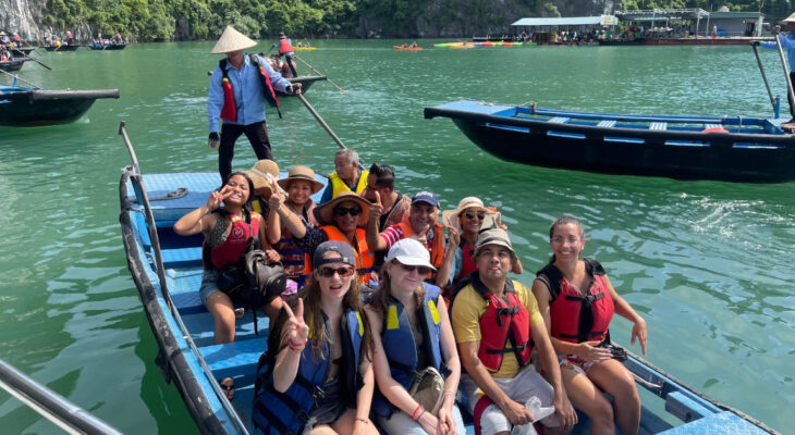 Halong Odyssey Cruise guests on bamboo boat.