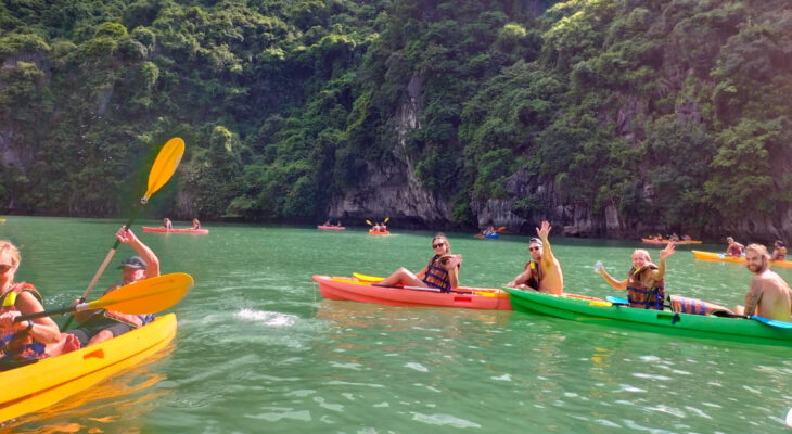 Halong Odyssey Cruise guests kayak in the bay.